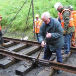 After swinging the track panels into position Bill Blake places and tightens the “golden bolt” on the first track joint watched by WRHA volunteers Iain MacIntosh, Alan Anderson, John Moore Scott, Andy Laing & Ian Cairns. July 2005.